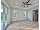 Main bedroom featuring a tray ceiling, fan, and natural lighting at 2089 Garnet St, North Port, FL 34288