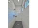 This walk-in shower is tiled with marble, a dark faucet, and sleek drain at 2089 Garnet St, North Port, FL 34288