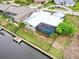 Aerial view of a beautiful waterfront home with screened pool and dock on a canal at 2160 Aqui Esta Dr, Punta Gorda, FL 33950
