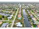Aerial view of a waterfront community with canals and single-Gathering homes at 2160 Aqui Esta Dr, Punta Gorda, FL 33950