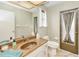 Bathroom featuring a granite countertop, decorative mirror and a door that leads outside at 2160 Aqui Esta Dr, Punta Gorda, FL 33950