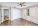 Neutral bedroom featuring laminate floors, closet with bi-fold doors, and window at 2160 Aqui Esta Dr, Punta Gorda, FL 33950