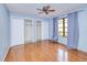 Bedroom with blue walls, wood flooring, large closet, and a sunny window with gray curtains at 2160 Aqui Esta Dr, Punta Gorda, FL 33950