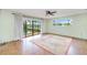 Bedroom featuring a ceiling fan, wood-look floors, view of the canal and access to the lanai at 2160 Aqui Esta Dr, Punta Gorda, FL 33950