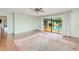 The primary bedroom has wood floors and sliding glass doors opening to the pool area at 2160 Aqui Esta Dr, Punta Gorda, FL 33950