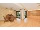 Dining room with light hardwood floors and large sliding doors overlooking the pool at 2160 Aqui Esta Dr, Punta Gorda, FL 33950