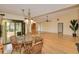 Dining room and living room combo, featuring hardwood floors, view to the pool, and large windows at 2160 Aqui Esta Dr, Punta Gorda, FL 33950