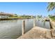 Concrete dock with wood pilings overlooking scenic canal waterway at 2160 Aqui Esta Dr, Punta Gorda, FL 33950