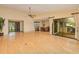 Expansive living area featuring wood floors, a ceiling fan, and sliding doors with pool views at 2160 Aqui Esta Dr, Punta Gorda, FL 33950