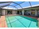 Enjoy the pool in this screened-in enclosure with views of the backyard and the home's other features at 2160 Aqui Esta Dr, Punta Gorda, FL 33950