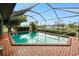 Relaxing pool area with brick patio and screened enclosure to provide an outdoor space for entertainment at 2160 Aqui Esta Dr, Punta Gorda, FL 33950