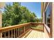 Relaxing outdoor balcony features wood flooring and a railing, offering scenic views of the lush greenery at 22481 Westchester Blvd # B48, Punta Gorda, FL 33980