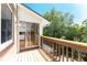 Relaxing outdoor balcony features wood flooring and a brown railing, offering scenic views of the lush greenery at 22481 Westchester Blvd # B48, Punta Gorda, FL 33980