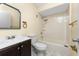 Cozy bathroom features a vanity with dark wood cabinets and a shower-tub combo at 22481 Westchester Blvd # B48, Punta Gorda, FL 33980