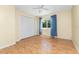This bedroom has light yellow walls, light wood-style floors and double-door closet at 22481 Westchester Blvd # B48, Punta Gorda, FL 33980