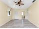 Well-lit bedroom featuring sleek floors, ceiling fan and entry to attached bath at 22481 Westchester Blvd # B48, Punta Gorda, FL 33980