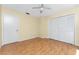 This bedroom has light yellow walls, light wood-style floors and double-door closet at 22481 Westchester Blvd # B48, Punta Gorda, FL 33980
