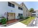 Exterior view shows maintained landscaping and a brick entry to the condominium building at 22481 Westchester Blvd # B48, Punta Gorda, FL 33980