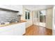 Galley kitchen with double sink, white cabinets, butcher block countertops, and a sliding door to the outside deck at 22481 Westchester Blvd # B48, Punta Gorda, FL 33980