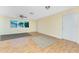 Bright living room with ceiling fan, tan walls, light floors and view of the complex through the window at 22481 Westchester Blvd # B48, Punta Gorda, FL 33980