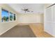 Bright living room featuring hardwood floors, large windows, and a modern ceiling fan at 22481 Westchester Blvd # B48, Punta Gorda, FL 33980