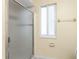 Bright shower stall featuring frosted glass doors, a window, and neutral walls at 22481 Westchester Blvd # B48, Punta Gorda, FL 33980