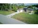 Overhead shot of house with green lawn, and driveway at 23273 Abeline Ave, Punta Gorda, FL 33980