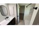 Bathroom featuring modern sink and vanity, walk-in shower with updated fixtures at 23273 Abeline Ave, Punta Gorda, FL 33980