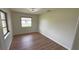 Minimalist bedroom with hardwood floors and plenty of natural light from the window at 23273 Abeline Ave, Punta Gorda, FL 33980