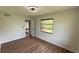 Bedroom with hardwood floors, modern ceiling fan, and natural light at 23273 Abeline Ave, Punta Gorda, FL 33980