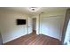Bedroom with wood-look flooring, closet, and ceiling fan with modern light fixture at 23273 Abeline Ave, Punta Gorda, FL 33980