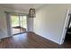 Dining area with wood-look flooring, decorative lighting, and sliding door access at 23273 Abeline Ave, Punta Gorda, FL 33980