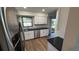 Modern kitchen with stainless steel appliances, white cabinets, and dark countertops at 23273 Abeline Ave, Punta Gorda, FL 33980