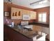 Well-lit kitchen with granite countertops, modern appliances, and bright, natural wood cabinets at 25050 Sandhill Blvd # A2, Punta Gorda, FL 33983