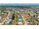 Breathtaking aerial view emphasizing the home and the distant lakes, nestled within a sprawling, verdant neighborhood at 25371 Paladin Ln, Punta Gorda, FL 33983