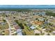 Scenic aerial panorama showcasing the home and the distant lake, complemented by the sprawling green landscape at 25371 Paladin Ln, Punta Gorda, FL 33983