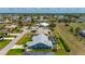 Captivating aerial view capturing the home's screened-in pool and the lush greenery of the surrounding landscape at 25371 Paladin Ln, Punta Gorda, FL 33983