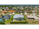 Expansive aerial perspective highlighting the home's inviting screened-in pool and the vibrant neighborhood at 25371 Paladin Ln, Punta Gorda, FL 33983