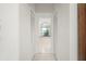 Hallway view of a bathroom with tile floors, a bathtub, and natural light at 25371 Paladin Ln, Punta Gorda, FL 33983