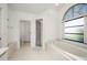 Clean bathroom with a large window, soaking tub, and walk-in shower at 25371 Paladin Ln, Punta Gorda, FL 33983