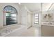 Bright bathroom features a bathtub, double vanity, and natural light at 25371 Paladin Ln, Punta Gorda, FL 33983