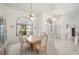 Bright dining room with large arched window, decorative ceiling fan, and views to other rooms in the house at 25371 Paladin Ln, Punta Gorda, FL 33983