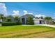 Desirable home with manicured lawn, mature landscaping, arched entryway, and a two-car garage, perfect for Gathering living at 25371 Paladin Ln, Punta Gorda, FL 33983