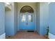 Inviting front door with decorative glass, complemented by a tiled walkway, and landscaping, creating a welcoming ambiance at 25371 Paladin Ln, Punta Gorda, FL 33983