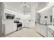 All-white kitchen features stainless steel appliances, ample storage, and overlooks breakfast bar at 25371 Paladin Ln, Punta Gorda, FL 33983