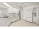 Bright kitchen with white cabinets, tile flooring, and ample counter space at 25371 Paladin Ln, Punta Gorda, FL 33983
