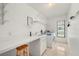 Bright laundry room with sink, counter space, and built in shelving at 25371 Paladin Ln, Punta Gorda, FL 33983