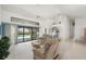 Bright living room featuring comfortable seating, ceiling fan, access to lanai and multiple rooms at 25371 Paladin Ln, Punta Gorda, FL 33983