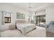 Main bedroom with carpet, slider to patio, ceiling fan, and ample natural light at 25371 Paladin Ln, Punta Gorda, FL 33983