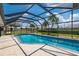 Screened-in pool area with sparkling blue water and lush landscaping at 25371 Paladin Ln, Punta Gorda, FL 33983